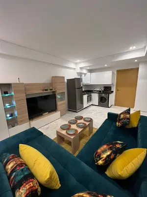 a living room with a blue couch and yellow pillows at PALACE B Av Hassan II Marrakech 40000 -Brand New Luxury UNIT#2 & UNIT#29 in Marrakech