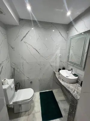 a white bathroom with a toilet and a sink at PALACE B Av Hassan II Marrakech 40000 -Brand New Luxury UNIT#2 & UNIT#29 in Marrakech