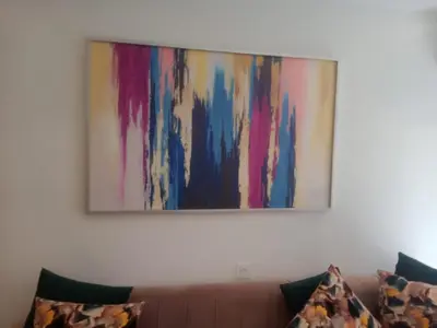a painting hanging on a wall above a couch at PALACE B Av Hassan II Marrakech 40000 -Brand New Luxury UNIT#2 & UNIT#29 in Marrakech