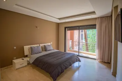 a bedroom with a bed and a large window at studio design carre eden gueliz IPTV , NETFLIX , WIFI, in Marrakech
