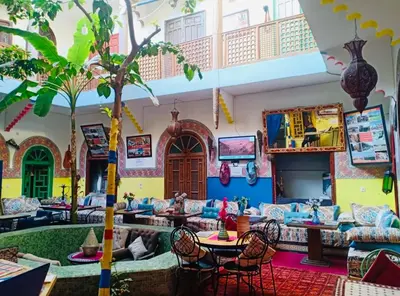 a living room with couches and a palm tree at Riad Dia in Marrakech