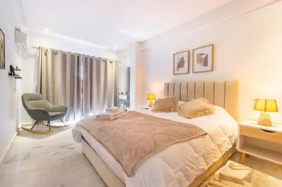 a bedroom with a large bed and a chair at NEW! Élégance, Gueliz, Terrase, IPTV in Marrakech