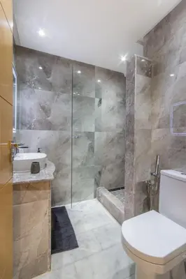 a bathroom with a shower and a toilet and a sink at NEW! Élégance, Gueliz, Terrase, IPTV in Marrakech