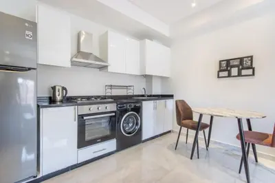 a kitchen with a stove and a table at NEW! Élégance, Gueliz, Terrase, IPTV in Marrakech