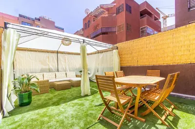 a patio with a table and chairs on the grass at NEW!, Jardin privé, transats, barbecue in Marrakech