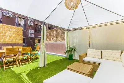 a patio with a tent with a table and chairs at NEW!, Jardin privé, transats, barbecue in Marrakech