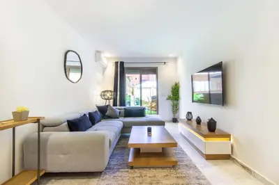 a living room with a couch and a table at NEW!, Jardin privé, transats, barbecue in Marrakech