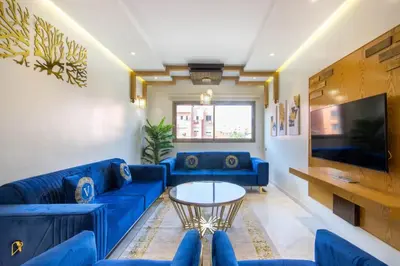 a living room with blue couches and a table at NEW! Appartement de luxe emplacement idéal Gueliz in Marrakech