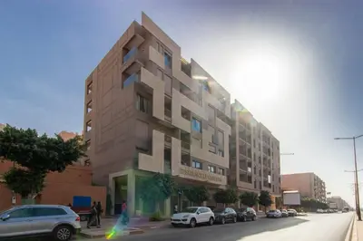 a building on a street with cars parked in front of it at NEW! Appartement de luxe emplacement idéal Gueliz in Marrakech