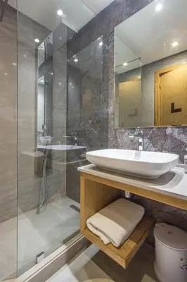 a bathroom with a sink and a glass shower at NEW! Appartement de luxe emplacement idéal Gueliz in Marrakech