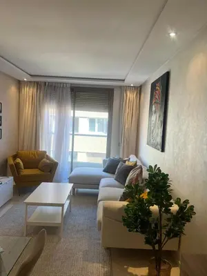 a living room with a couch and a table at APPARTEMENT CARRE EDEN in Marrakech