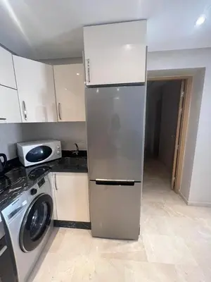 a kitchen with a refrigerator and a washing machine at APPARTEMENT CARRE EDEN in Marrakech