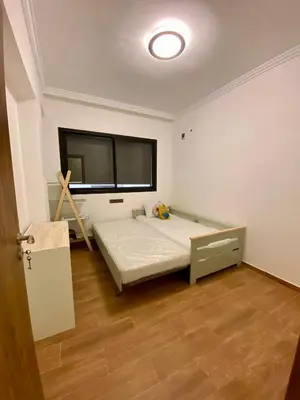 a bedroom with a bed and a large window at Appartement 2 chambres salon centre de Gueliz 19 in Marrakech