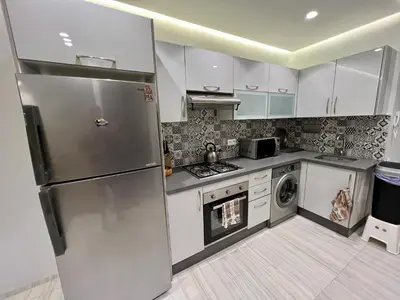 a kitchen with a stainless steel refrigerator and a dishwasher at Appartement 2 chambres salon a cote centre de Gueliz 12 in Marrakech