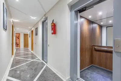 a corridor of a hallway with a fire extinguisher on the wall at New! Appartemant au millieu de guéliz in Marrakech