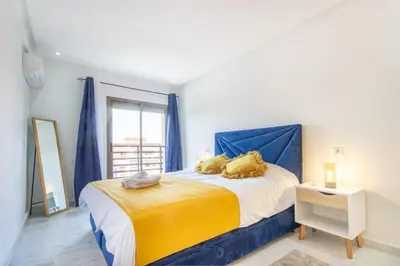 a bedroom with a bed with two pillows on it at NEW! Gueliz,Terrasse, Fibre optique, IPTV in Marrakech