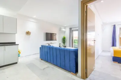 a kitchen and living room with a large glass doorway at NEW! Gueliz,Terrasse, Fibre optique, IPTV in Marrakech