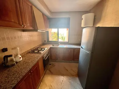 a kitchen with a stainless steel refrigerator and a window at Appartement les résidences du rêve in Marrakech