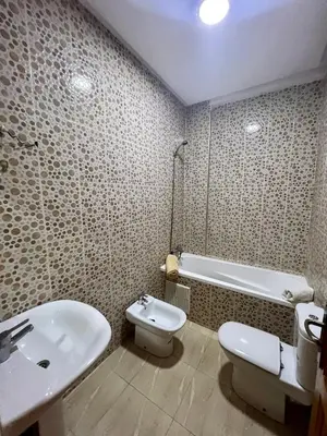 a bathroom with a sink and a toilet and a tub at Appartement les résidences du rêve in Marrakech