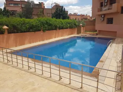 a swimming pool on the balcony of a building at Appartement les résidences du rêve in Marrakech