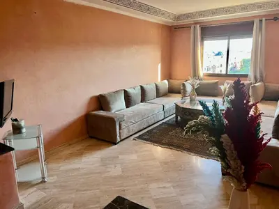 a living room with a couch and a table at Appartement les résidences du rêve in Marrakech