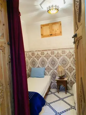 a small room with a bed and a table at Maison 211 in Marrakech