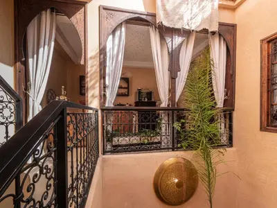 a stairway with a balcony with a plant at Riad Oumnia - Top emplacement - Riad en entier - Jacuzzi in Marrakech