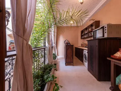a hallway with a balcony with plants in a house at Riad Oumnia - Top emplacement - Riad en entier - Jacuzzi in Marrakech
