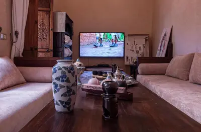 a living room with two couches and a tv at Riad Oumnia - Top emplacement - Riad en entier - Jacuzzi in Marrakech