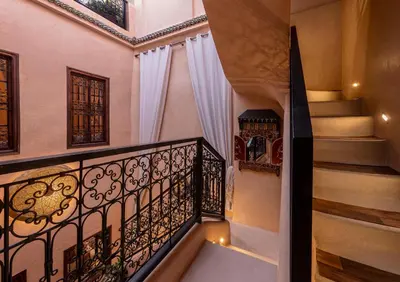a staircase in a home with a wrought iron railing at Riad Oumnia - Top emplacement - Riad en entier - Jacuzzi in Marrakech