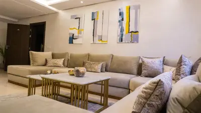 a living room with a couch and a table at Luxury Modern Apartment in the heart of Marrakesh. in Marrakech