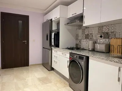 a kitchen with a washer and a dishwasher at Luxury Modern Apartment in the heart of Marrakesh. in Marrakech