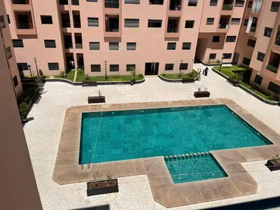 an overhead view of a swimming pool in front of a building at Luxury Modern Apartment in the heart of Marrakesh. in Marrakech