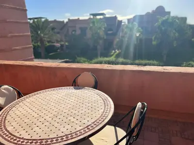 a table and chairs sitting on a balcony at atlas golf resort marrakech 