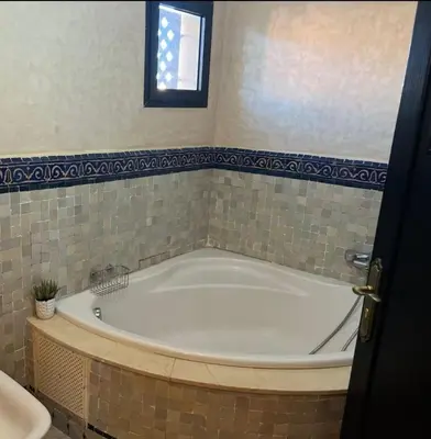 a bath tub in a bathroom with a window at atlas golf resort marrakech 