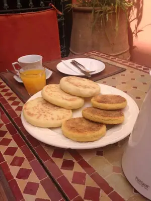 a plate of breads on top of a table at Riad La Perle de Marrakech in Marrakech