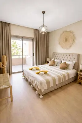 a bedroom with a large bed with a large window at Prestigia Marrakech Dar Cheryana in Marrakech