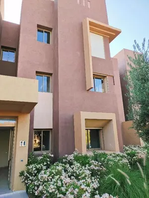 a pink building with flowers in front of it at Prestigia Marrakech Dar Cheryana in Marrakech