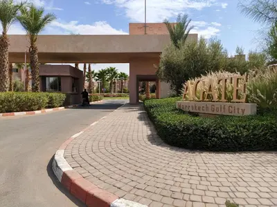 a building with a sign that reads village artificial gulf city at Prestigia Marrakech Dar Cheryana in Marrakech