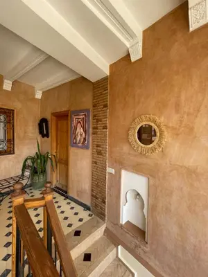 a staircase in a house with a wall at Riad Les Miroirs in Marrakech
