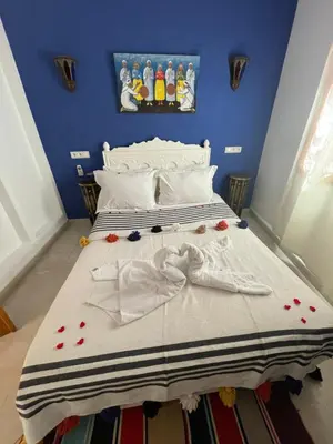 a bedroom with a bed with flowers on it at Riad Les Miroirs in Marrakech