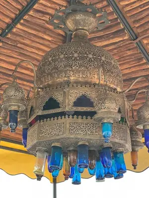 a chandelier with blue glasses hanging from a ceiling at Riad dar Rbati in Marrakech