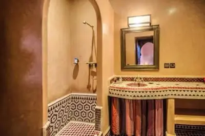 a bathroom with a sink and a shower and a mirror at RIAD Le MINASDAM in Marrakech