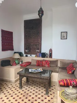 a living room with a couch and a table at Riad Parfum d'Orient in Marrakech