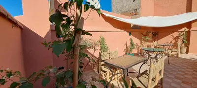 a table and chairs on the side of a building at Riad Parfum d'Orient in Marrakech