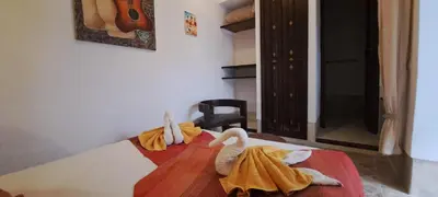 a bedroom with two swans towels on a bed at Riad Parfum d'Orient in Marrakech