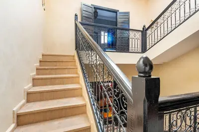 a staircase with a wrought iron railings and a window at Riad Anir in Marrakech