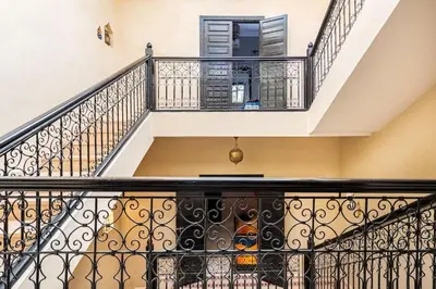 a staircase with black railings in a house at Riad Anir in Marrakech