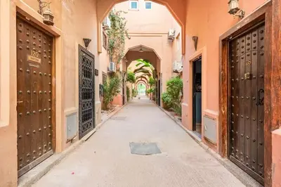 an alley in an old town with gates and an arcade at Riad Anir in Marrakech