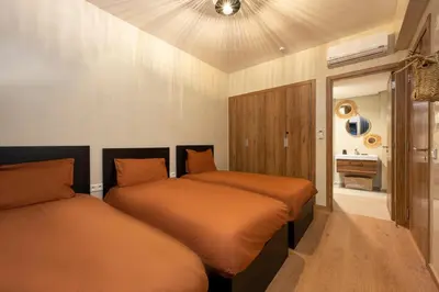 a bedroom with two beds and a ceiling at LDM Appartements Marrakech in Marrakech